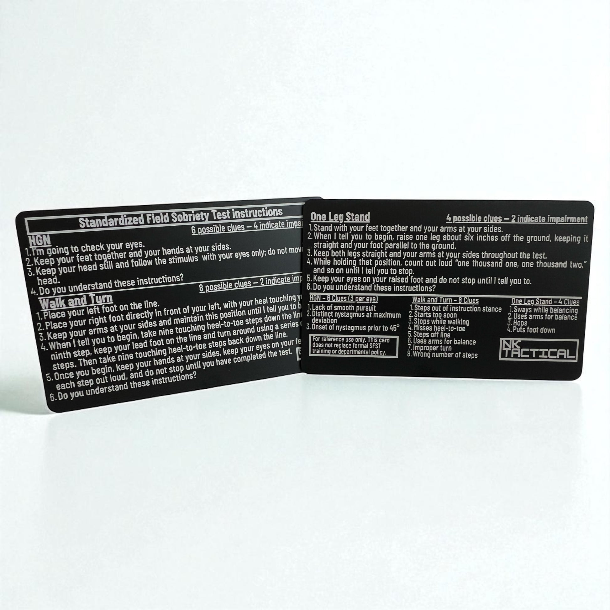 Close-up of two metal SFST instruction cards showing detailed field sobriety test instructions and engraved NK Tactical branding.