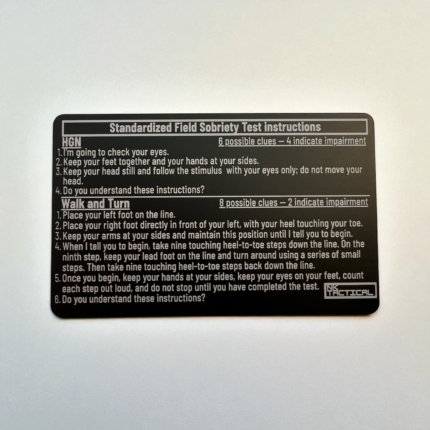 Front side of metal SFST instruction card showing HGN and Walk-and-Turn test steps, laser-engraved anodized aluminum card by NK Tactical.