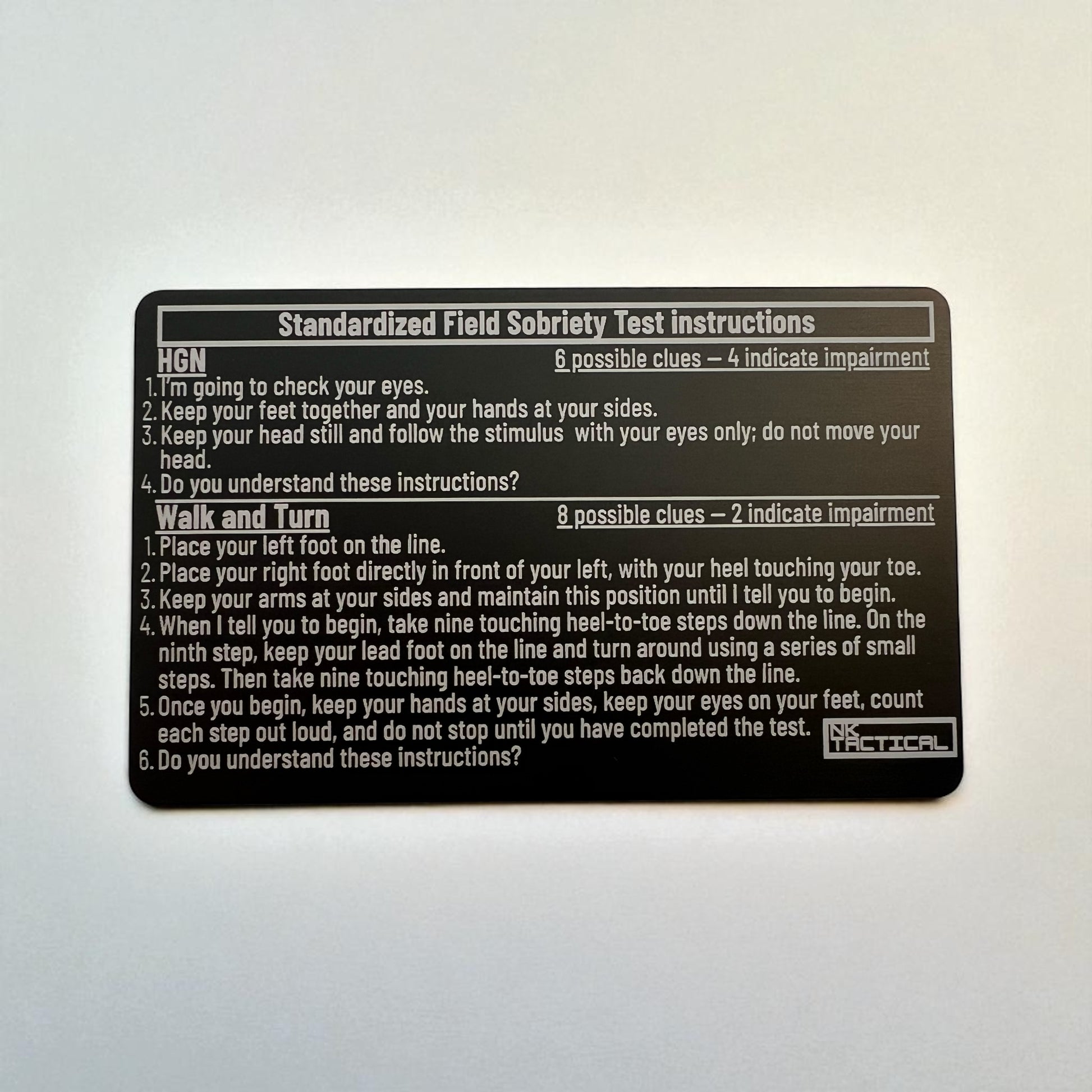 Front side of metal SFST instruction card showing HGN and Walk-and-Turn test steps, laser-engraved anodized aluminum card by NK Tactical.