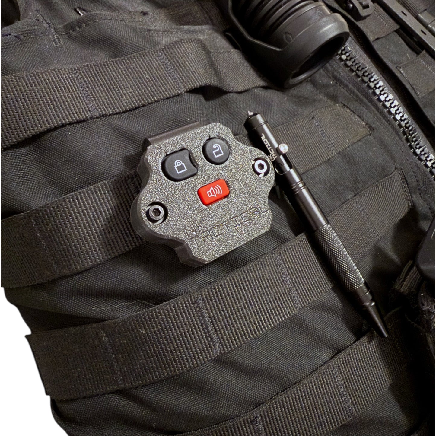 NK Tactical MOLLE-mounted Ford key fob installed on duty vest next to tactical pen for scale and real-world use