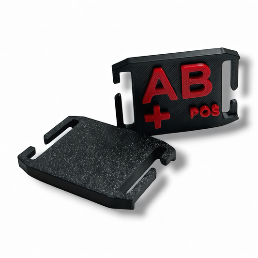 Front and back views of an NK Tactical AB positive MOLLE blood type tag showing the red identification lettering and attachment clips.